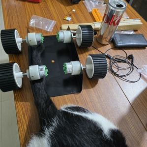 Four-wheel rover chassis assembled on a table.
